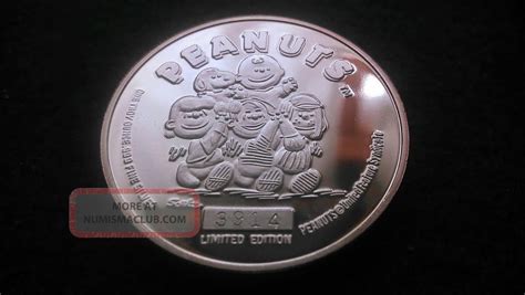 silver snoopy 50th anniversary medallion.